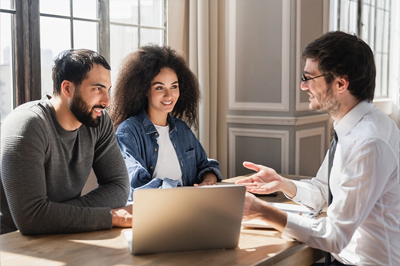 Mortgage advisor helping happy couple